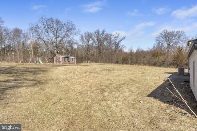 view of yard with an outdoor structure and central AC unit