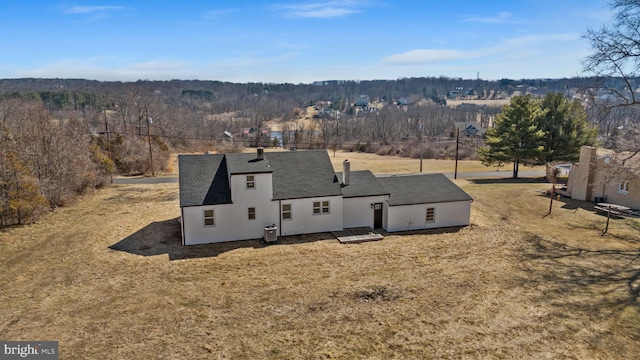 birds eye view of property featuring a wooded view