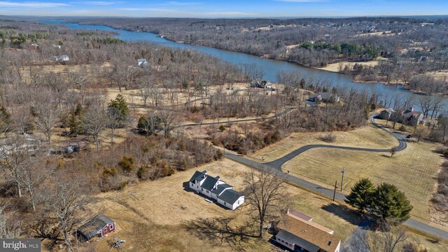 bird's eye view with a forest view and a water view