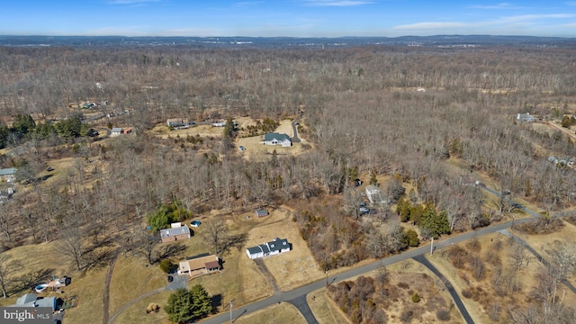 birds eye view of property featuring a forest view