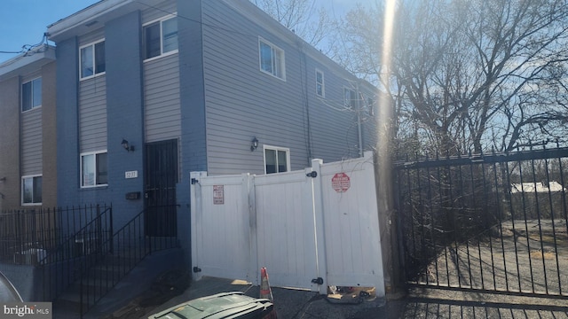 view of home's exterior with a gate and fence