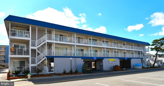 view of building exterior with uncovered parking