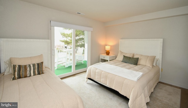 bedroom with visible vents, baseboards, and access to exterior