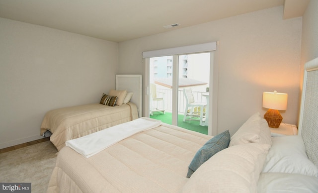 bedroom with visible vents, baseboards, and access to outside