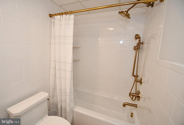 full bath with shower / bath combination with curtain, toilet, and tile walls