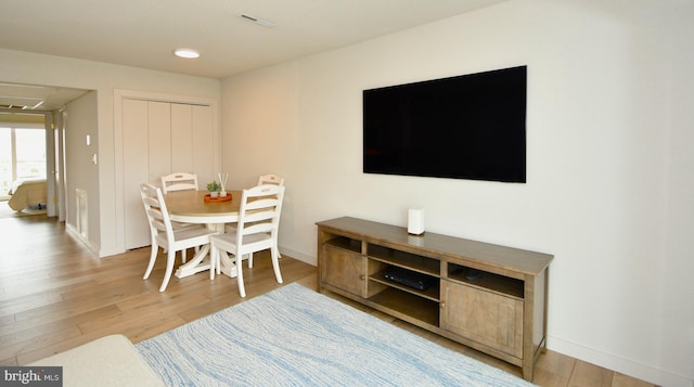 dining room featuring baseboards and light wood finished floors