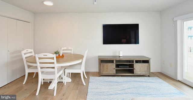 dining room with baseboards and wood finished floors