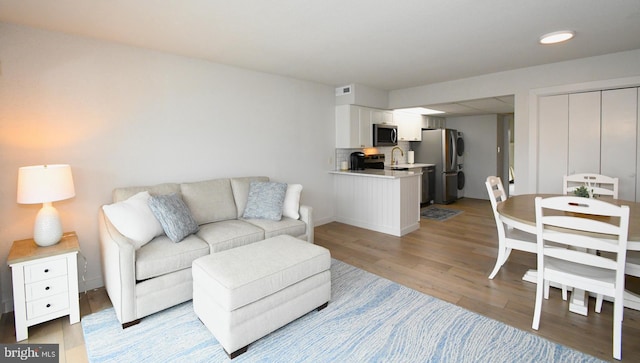 living area featuring light wood-type flooring and visible vents