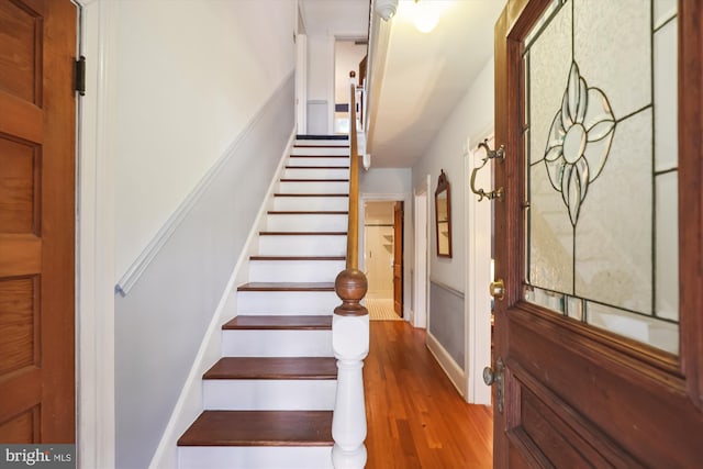 stairway featuring wood finished floors