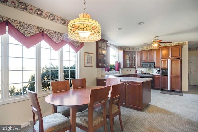 dining area featuring a ceiling fan, visible vents, light colored carpet, and baseboards