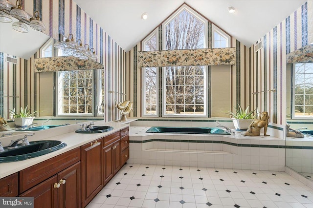 full bath featuring wallpapered walls, lofted ceiling, and a sink