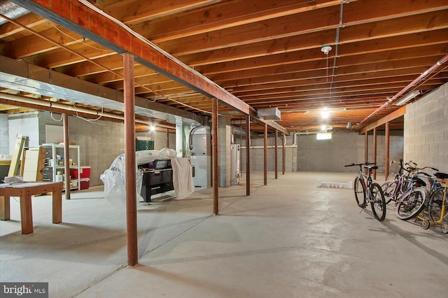 unfinished basement featuring heating unit and water heater