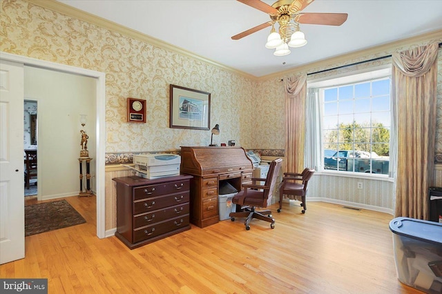 office area featuring light wood finished floors, visible vents, wallpapered walls, crown molding, and baseboards