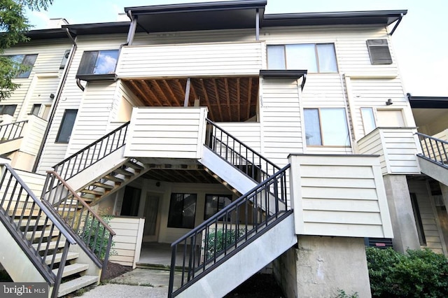 back of property featuring stairs