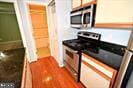 kitchen featuring stainless steel appliances and dark wood-type flooring