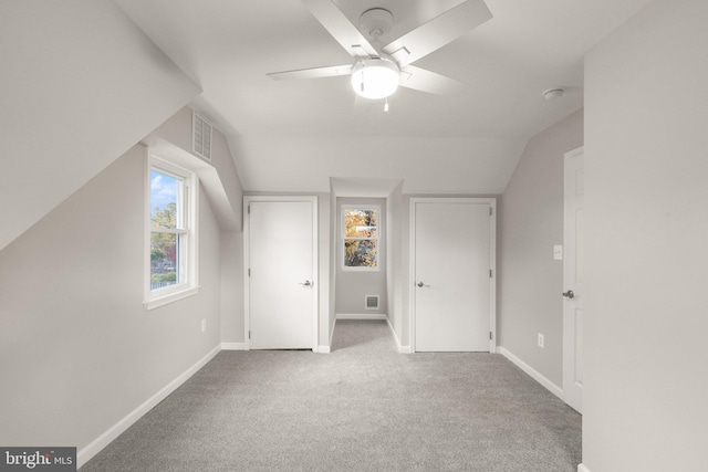 additional living space featuring lofted ceiling, a ceiling fan, baseboards, and carpet floors