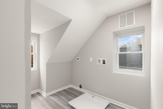 laundry room featuring visible vents, wood finished floors, baseboards, hookup for an electric dryer, and hookup for a washing machine