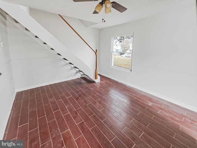 interior space with dark wood finished floors, stairway, a ceiling fan, and baseboards