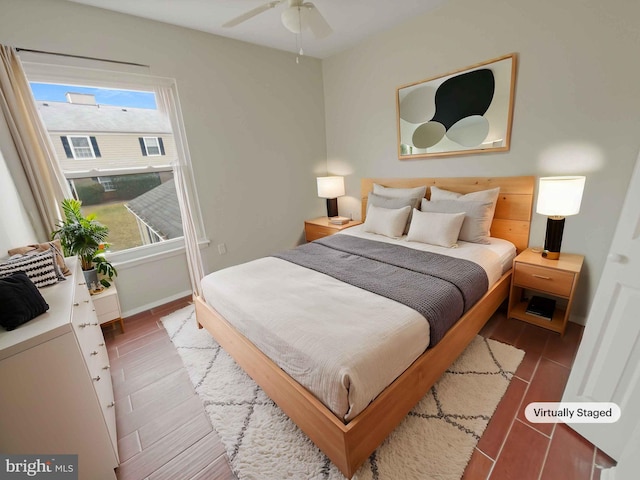 bedroom with baseboards and wood finished floors