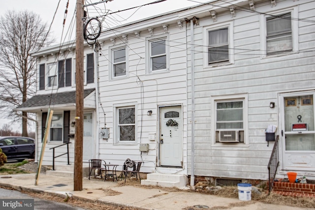 view of front of property with cooling unit and entry steps