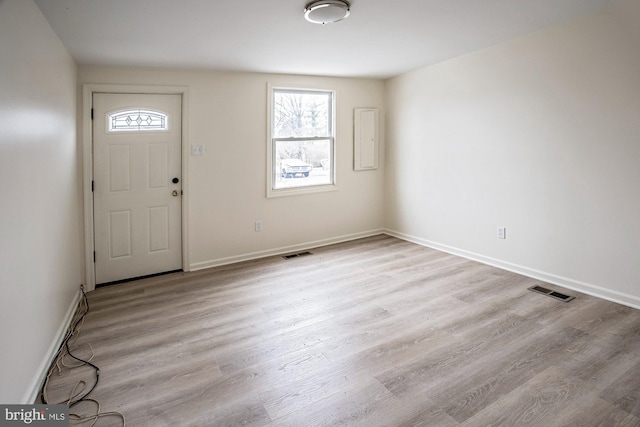 entryway featuring visible vents, baseboards, and wood finished floors