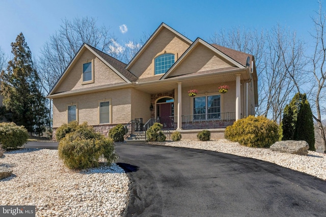 view of front of property featuring stucco siding and a porch