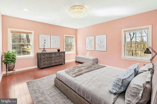 bedroom with baseboards and wood finished floors