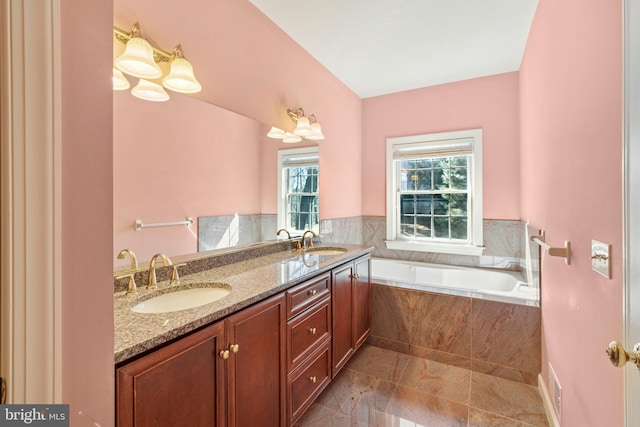 full bath featuring a bath, double vanity, and a sink