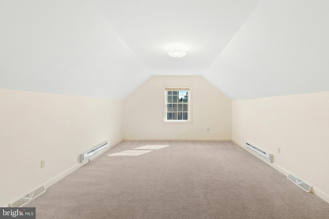 bonus room featuring visible vents, light colored carpet, a baseboard heating unit, and vaulted ceiling