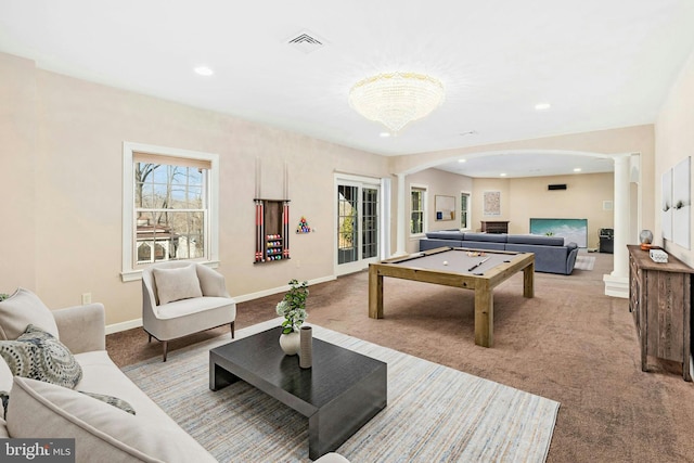 game room with visible vents, a healthy amount of sunlight, carpet flooring, and decorative columns