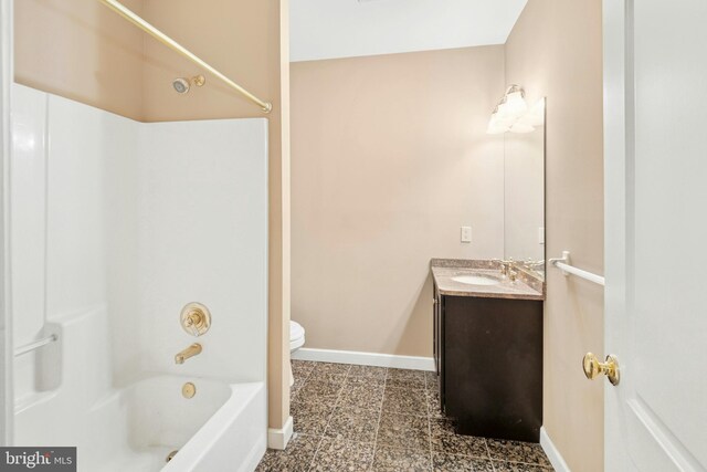 full bathroom with vanity, toilet, baseboards, and shower / bath combination