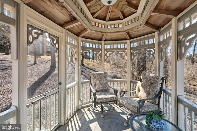 unfurnished sunroom with plenty of natural light and wood ceiling