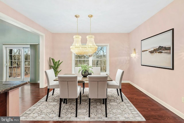 dining room with baseboards, a notable chandelier, and dark wood-style floors