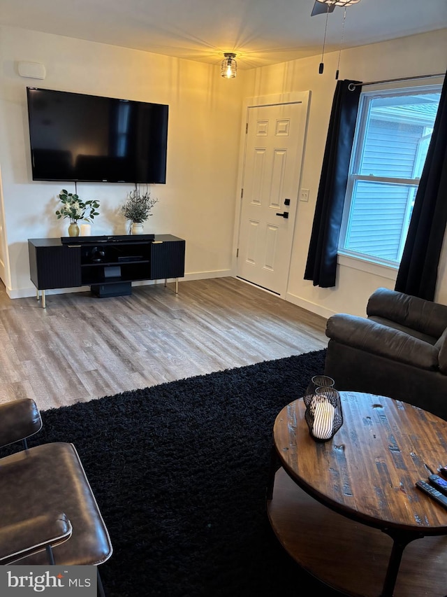 living area with wood finished floors and baseboards