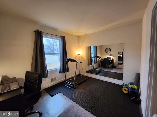 exercise area featuring visible vents and baseboards