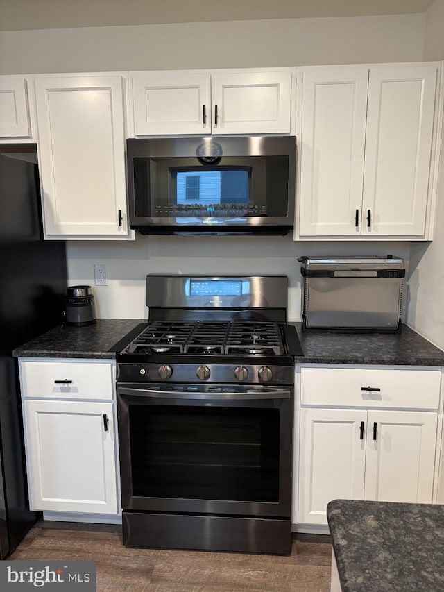 kitchen with white cabinets and appliances with stainless steel finishes