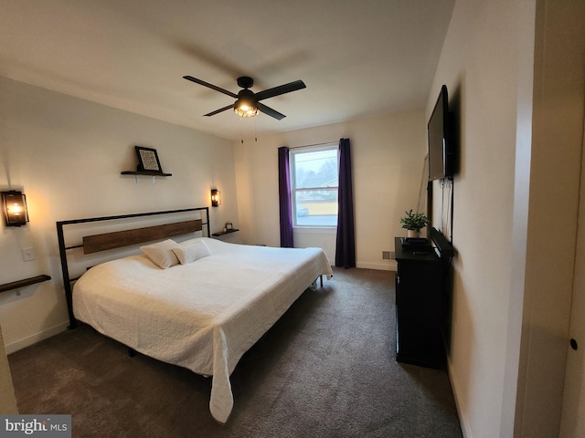 bedroom featuring a ceiling fan, baseboards, and dark carpet