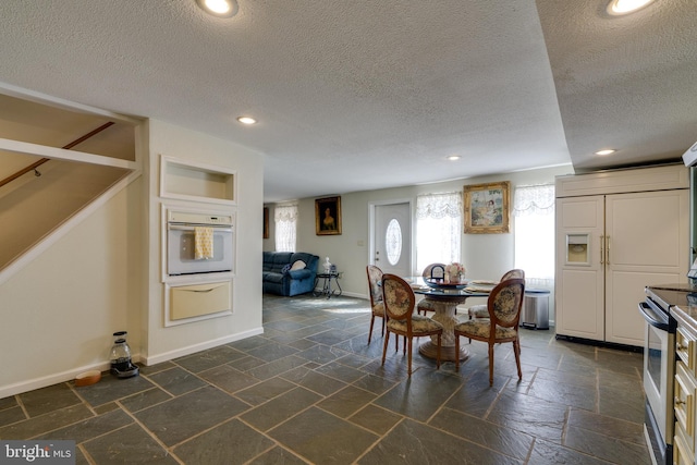 dining space featuring baseboards, stairs, stone tile floors, recessed lighting, and a textured ceiling