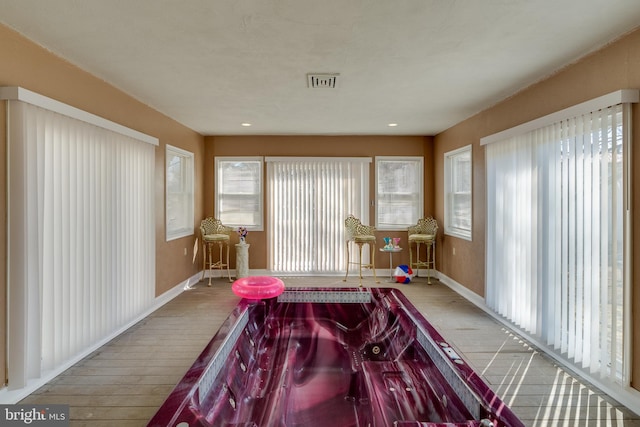 rec room with recessed lighting, visible vents, light wood-style flooring, and baseboards