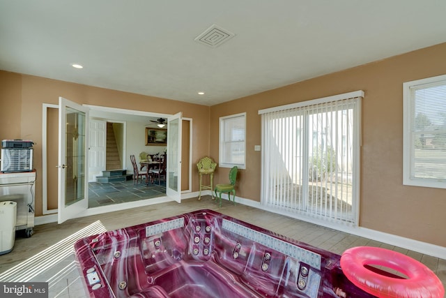 living area featuring recessed lighting, visible vents, baseboards, and wood finished floors