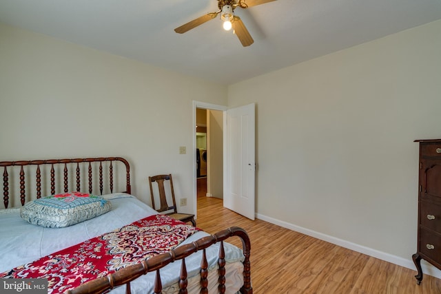 bedroom featuring wood finished floors, baseboards, and ceiling fan