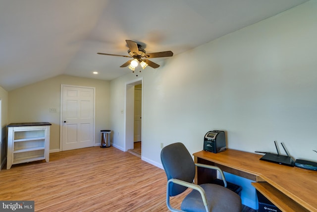 office area featuring vaulted ceiling, baseboards, light wood finished floors, and ceiling fan