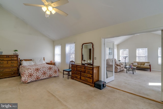 carpeted bedroom with multiple windows, a ceiling fan, and high vaulted ceiling