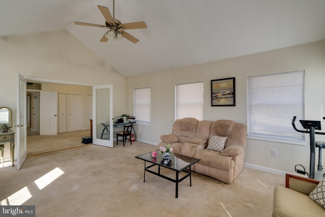 living room with baseboards, light colored carpet, high vaulted ceiling, and a ceiling fan