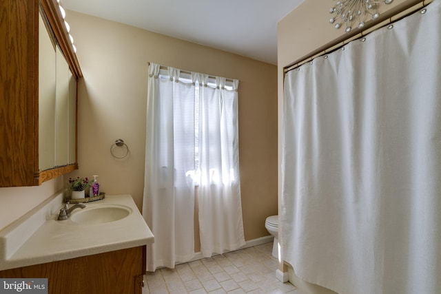 bathroom featuring toilet and vanity