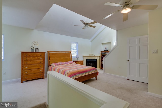 bedroom with lofted ceiling, a fireplace, baseboards, and light carpet