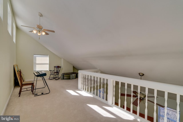 interior space featuring carpet, vaulted ceiling, and a ceiling fan