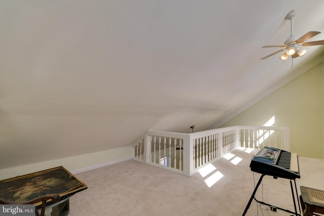 interior space featuring carpet, lofted ceiling, and a ceiling fan