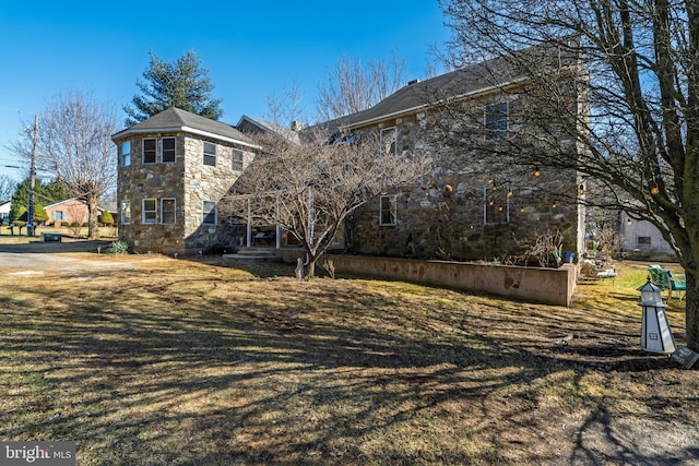 view of side of home with stone siding