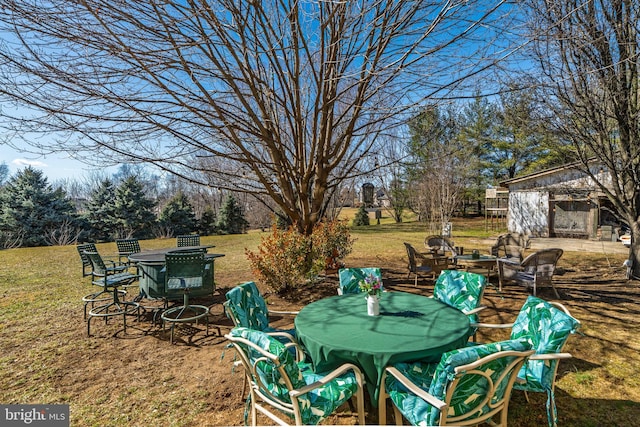 view of yard featuring outdoor dining area